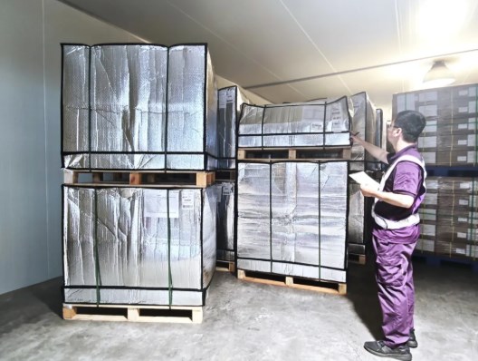 Warehouse specialist checking insulated pallets inside a temperature-controlled Shanghai facility